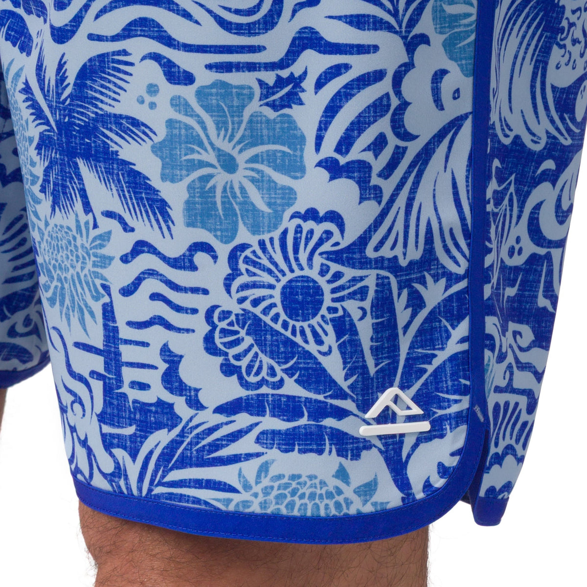 Close-up of the lower right side of Fayder Boardshort with blue floral surf-inspired pattern and comfort design details
