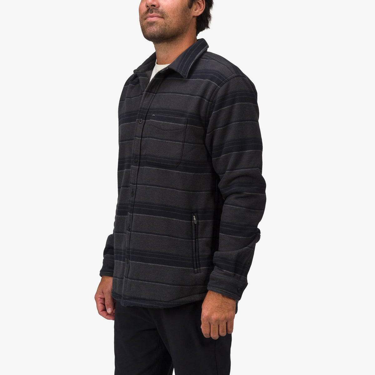 Man facing left wearing a Bartlett Woven Jacket in dark striped fabric, showcasing comfort-focused beach-inspired apparel.