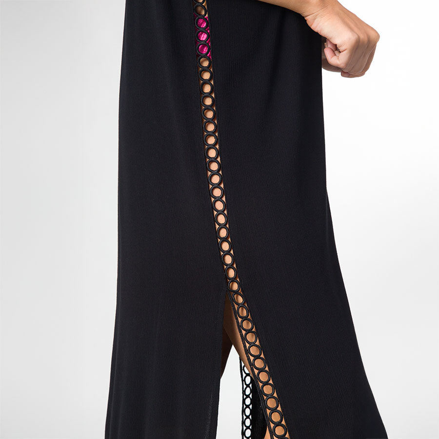 Close-up of the side slit detail on the Irina Shirt Dress showing black fabric with circular cutouts for a beach-inspired look