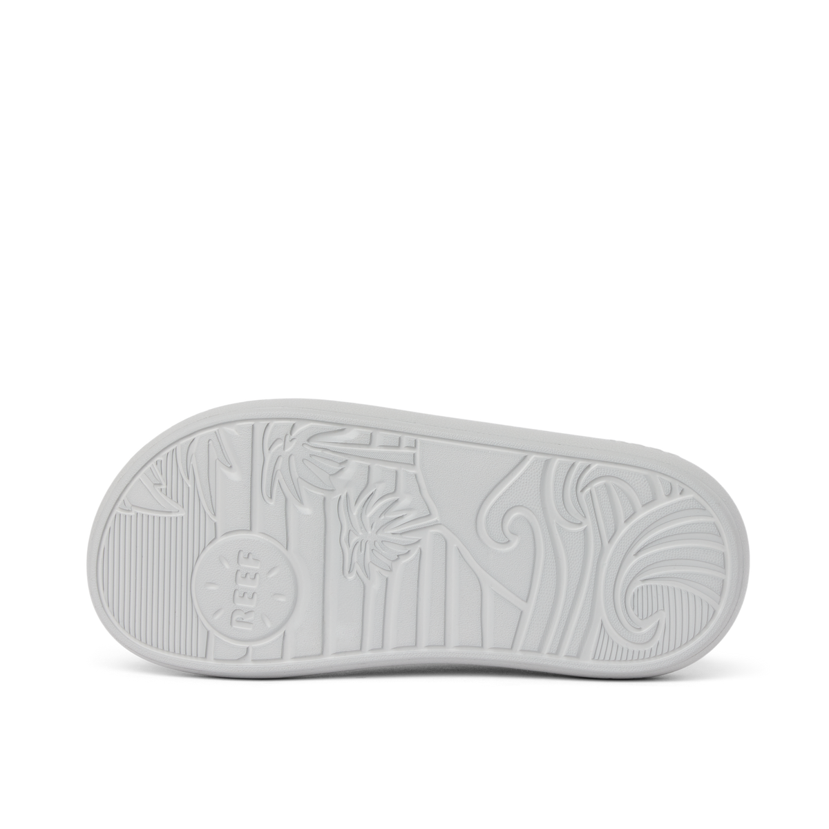 Kids Rio Slide outsole facing up showing textured beach-inspired sole with palm tree and wave patterns in light grey