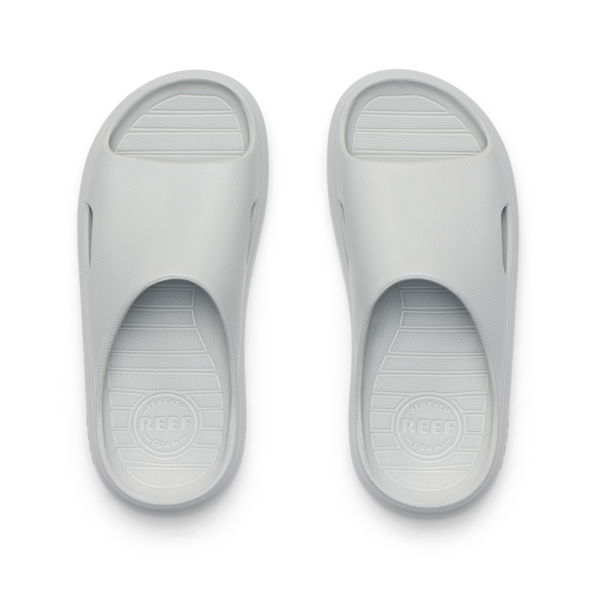Kids Rio Slide sandals in light grey, top view showing open toe and cushioned, water-friendly design facing upward.