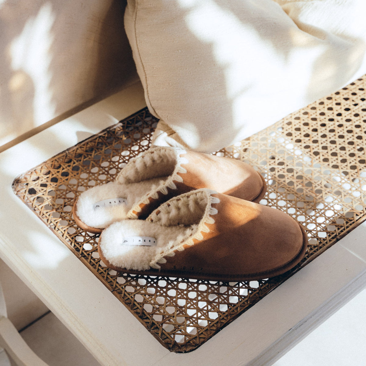 Iryss women's tan slip-on shoes facing left, close-up showing cushioned interior and soft, durable materials.