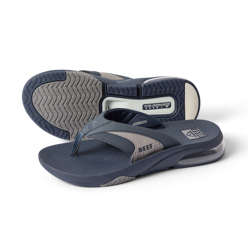 Fanning + men’s navy gray flip flops, angled left showing top and sole, comfort cushioning and arch support
