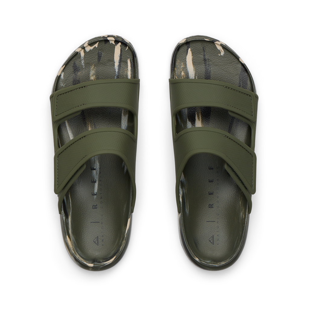 Top-down view of men's Oasis Adapt slides in green with camo marble footbeds, featuring anatomical arch support and soft cushioning.