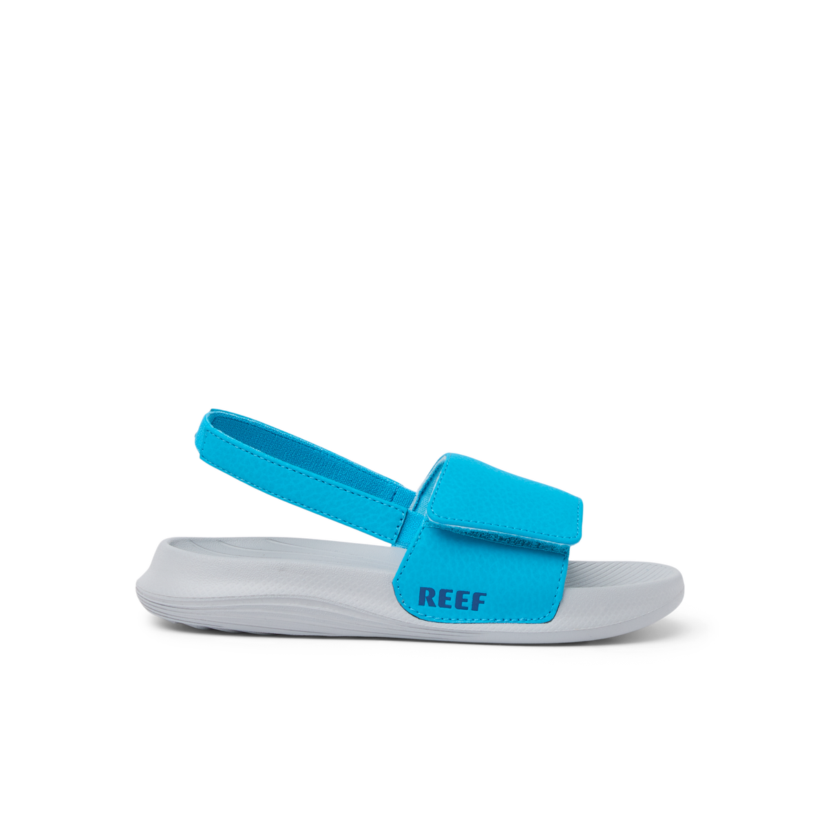 Little Salty Slide facing left, close-up of the blue strap and grey slide sole with REEF logo, beach-inspired comfort sandals.