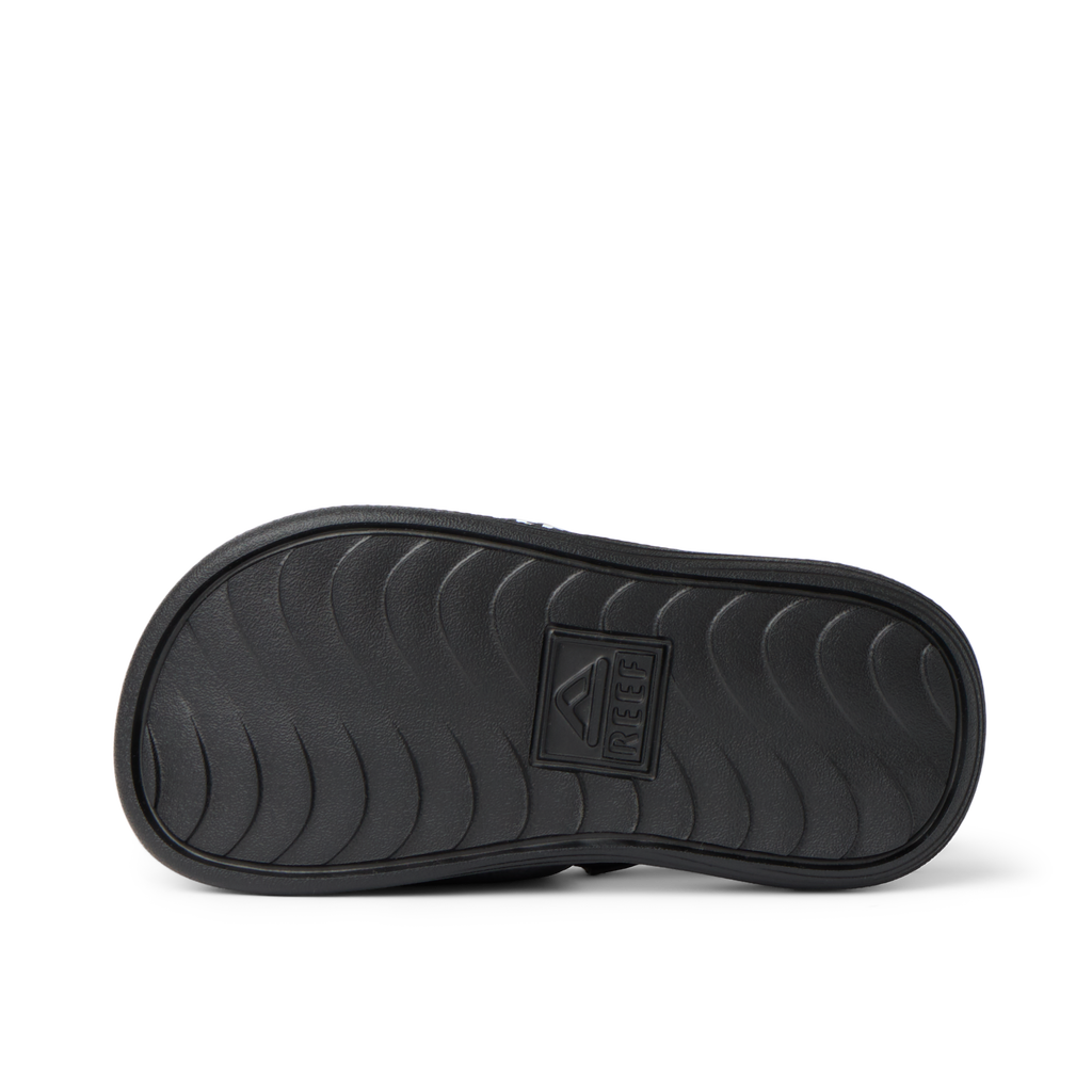 Kids Salty Slide showing the sole with wave-pattern grip, designed for comfort and durability, facing downwards, boys size.