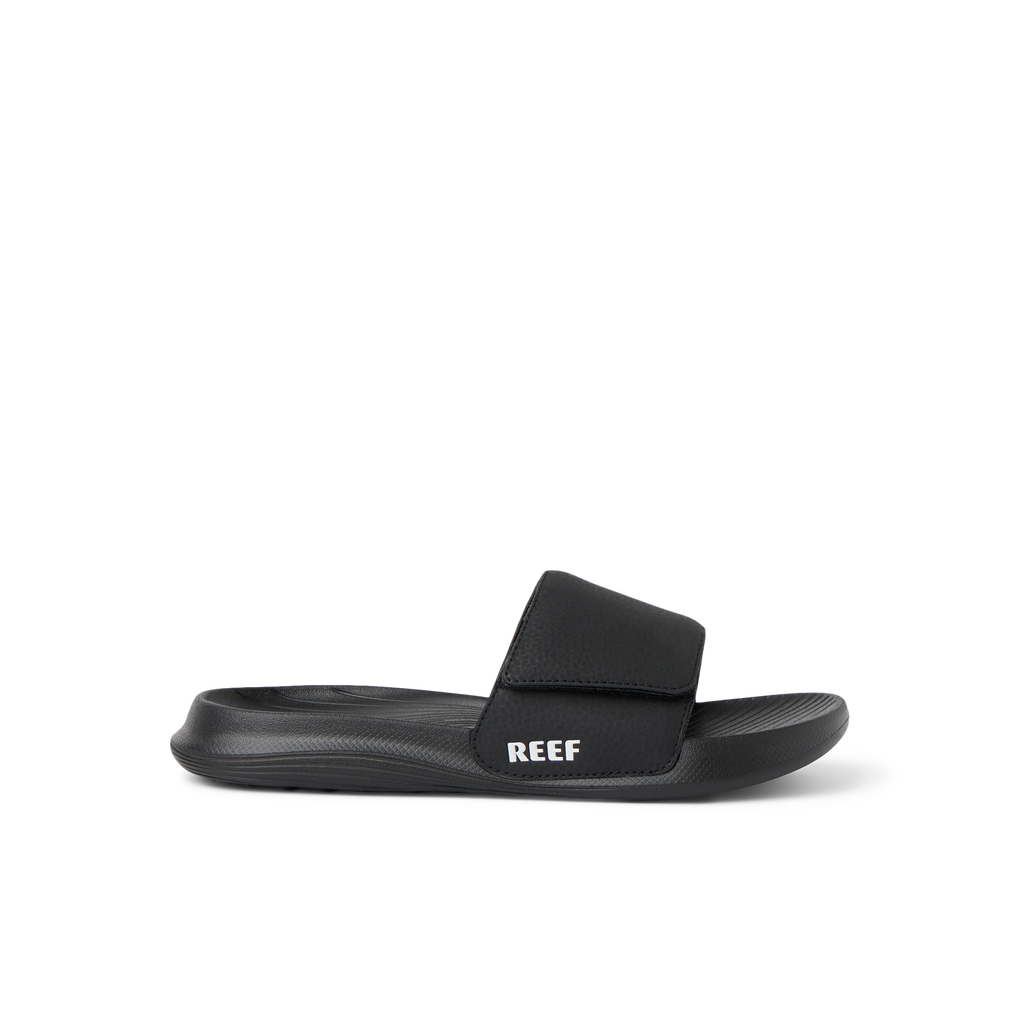 Kids Salty Slide black right-facing side view showing soft-rebound cushioning and anatomical arch support in a beach-inspired slide.