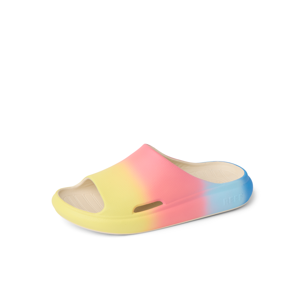 Kids Rio Slide sandal facing left with blue, pink, and yellow ombre colors, water-friendly and comfort-focused design.
