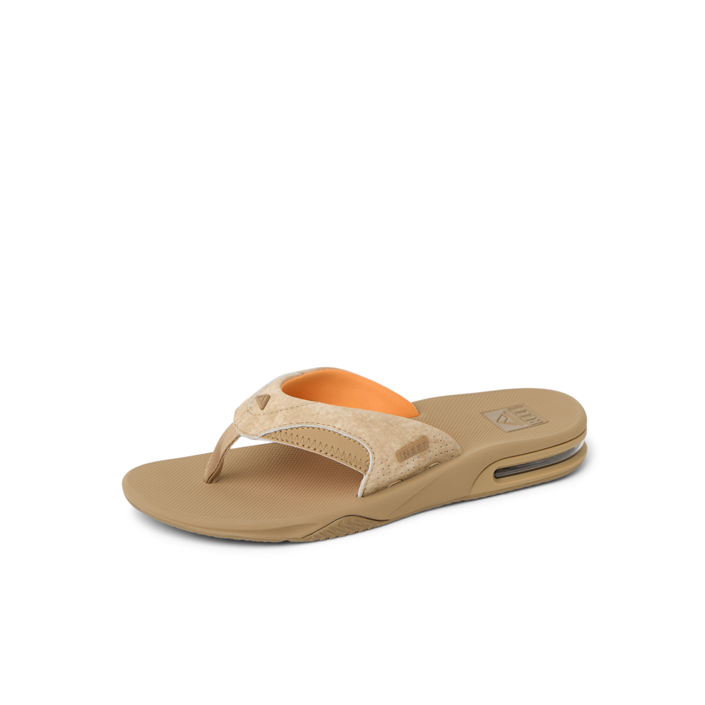 Fanning men's tan sandal facing right, close-up of cushioned arch support and water-friendly sole, beach-inspired comfort design.