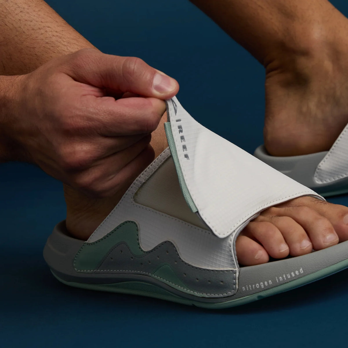 Close-up of the left Cruiser Slide facing right, showing adjustable upper strap and molded footbed with arch support.