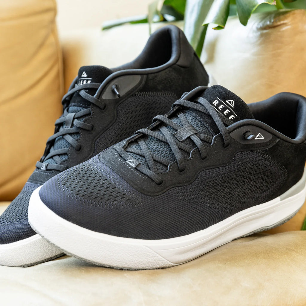 Pair of black Shoreline Del Mar sneakers facing right, showcasing breathable upper and cushioned sole, highlighting comfort and style.